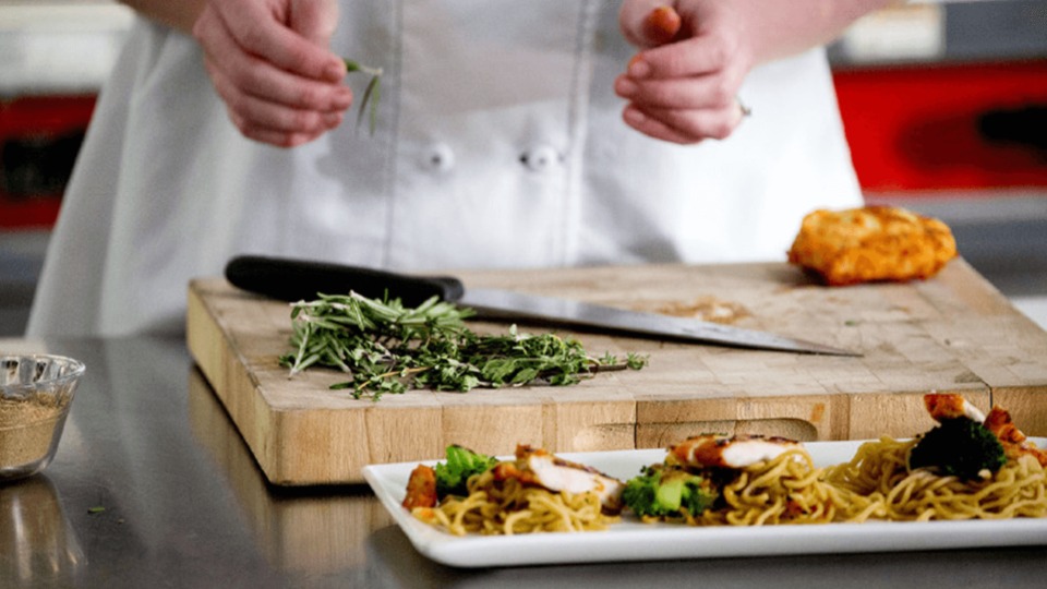 T3_CulinaryInnovation_LARGE_Carousel_2.jpg This is a photo of a chef preparing to cook.